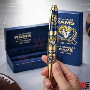 Los Angeles Rams 90th Anniversary 1936-2026 Pen 3 Hand holding a Los Angeles Rams 90th anniversary pen with gold and blue design in front of a blue gift box with team logo and anniversary text!