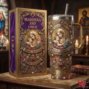 A decorative religious tumbler and box with Madonna and Child art stand on a wooden table with candles stained glass and classic church decor in the background!