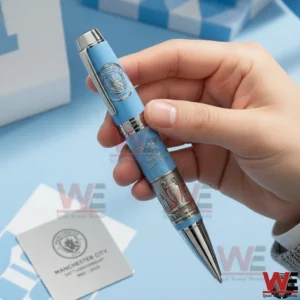 Hand holding a blue commemorative pen with silver tip and detailed engravings!