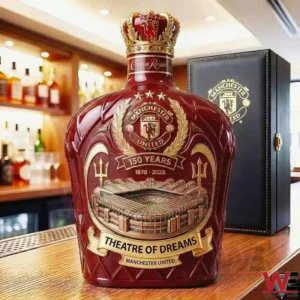 A detailed Crown Royal whisky bottle with Manchester United crest anniversary design and Old Trafford stadium artwork displayed on a bar surface!