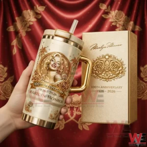 Gold metallic tumbler with vintage Hollywood inspired portrait ornate detailing straw lid and luxury packaging presented against a dramatic red stage backdrop!
