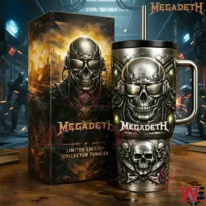 Silver and black Megadeth skull tumbler with metal straw and handle beside a matching collector box on a wooden table in an industrial room!