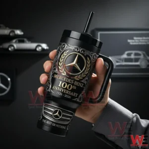 Hand holding a black Mercedes Benz one hundredth anniversary tumbler with handle and straw in a modern automotive themed background!