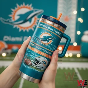 Hands holding a teal Miami Dolphins 60th anniversary insulated tumbler with handle and orange straw in front of a Dolphins themed backdrop.