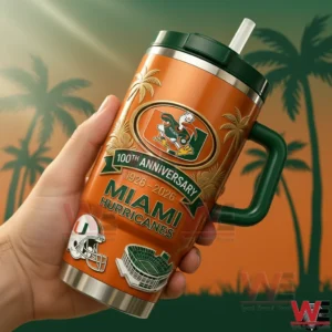 A Miami Hurricanes tumbler with a handle and straw displayed in a hand against a warm background with palm silhouettes!