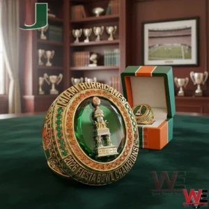 Championship ring with green gemstone and gold detailing displayed in a room filled with trophies and awards!