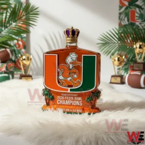 A Miami Hurricanes 2026 Fiesta Bowl Champions whiskey bottle featuring the U logo Sebastian mascot crown stopper and championship base displayed in a decorative football themed studio!