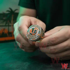 Miami Hurricanes Cotton Bowl Champions Custom Ring 3 Hands holding a Miami Hurricanes Cotton Bowl Champions ring featuring an orange and green U logo surrounded by gemstones.