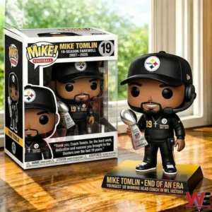 Football coach collectible figure holding a trophy displayed next to its presentation box on a table!