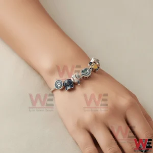 A wrist wearing a silver adjustable Milwaukee Brewers charm bracelet with multiple baseball themed charms including team logos a glove a helmet a baseball and stadium elements!
