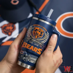 Hands holding a dark blue Chicago Bears anniversary insulated tumbler with handle and straw with a blurred Chicago Bears themed background!