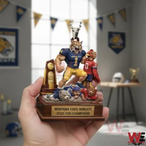 Hand holding a hanging car ornament of a bobcat football mascot celebrating a championship with trophy and defeated rivals on a detailed base!