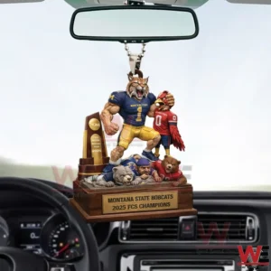 Car interior view with a hanging bobcat football mascot ornament celebrating a championship beneath the rearview mirror!