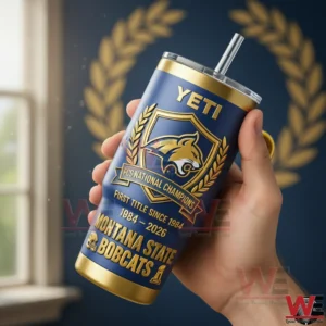 Hand holding a blue and gold Montana State Bobcats championship tumbler with straw and handle featuring a gold crest and FCS National Champions text!