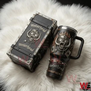 Dark insulated tumbler with handle and straw featuring a skull emblem next to a matching rugged box on a soft surface! v