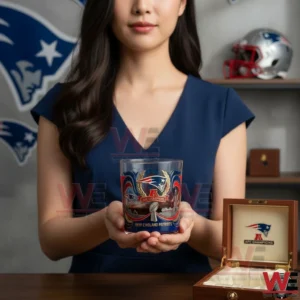 Woman holding a New England Patriots championship whiskey glass with team decor visible behind her!