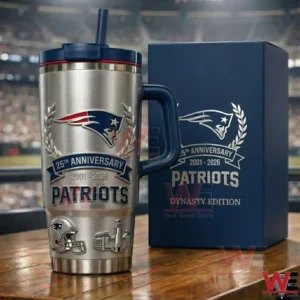 A metallic football anniversary tumbler with handle and straw displayed next to a dark blue box in a stadium environment!