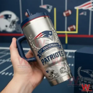A hand holding a silver football anniversary tumbler featuring engraved logos and classic sports styling!
