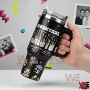 Hand holding a black New Kids On The Block tumbler with handle and concert themed graphics against a light background with retro shapes!