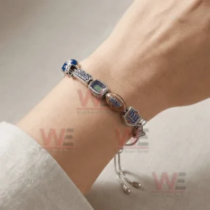 Silver adjustable charm bracelet worn on a wrist with New York Giants helmet Giants text stadium football NY logo and trophy charms plus an adjustable sliding clasp.
