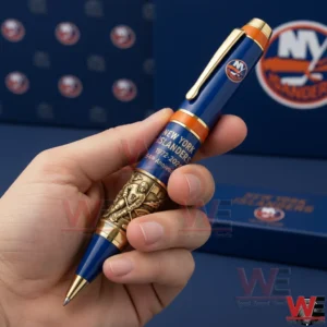 New York Islanders 54th Anniversary 1972-2026 Pen 3 Hand holding a blue and gold New York Islanders themed collectible pen with detailed engraving and display boxes in the background!