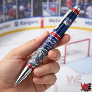 Hand holding a blue red and silver New York Rangers anniversary pen with 100th Anniversary 1926 2026 text in front of a hockey rink background!