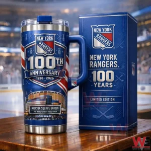 Blue New York Rangers one hundredth anniversary insulated tumbler with handle and lid next to a matching limited edition gift box on a wooden surface with a blurred hockey arena background!