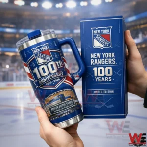 Hands holding a blue New York Rangers one hundredth anniversary stainless steel tumbler with handle and lid next to a matching limited edition gift box with a blurred hockey rink and arena lights behind!