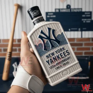 A person holding a New York Yankees themed whiskey bottle with anniversary markings displayed in a traditional baseball interior setting!