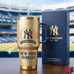 Gold New York Yankees one hundred twenty fifth anniversary tumbler with handle and straw beside a navy gift box in a baseball stadium background!