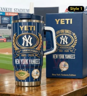 Navy pinstripe New York Yankees anniversary Yeti tumbler with straw and handle next to a matching blue box in a stadium setting.