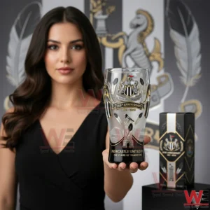 Woman holding a Newcastle United anniversary beer glass in a refined football heritage interior!