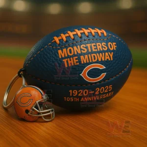 Navy and orange Bears football keychain with Monsters of the Midway text C logo 1920 2025 105th anniversary and a small helmet charm on a wooden table with stadium blur!