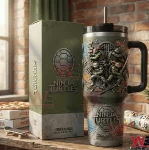 Green handled tumbler with embossed Ninja Turtles characters beside a matching gift box on a wooden table with pizza boxes and skateboard in a brick wall room!
