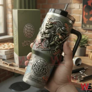 Hand holding a green handled tumbler with embossed Ninja Turtles characters in a pizza themed room with matching gift box pizza boxes and skateboard in the background!