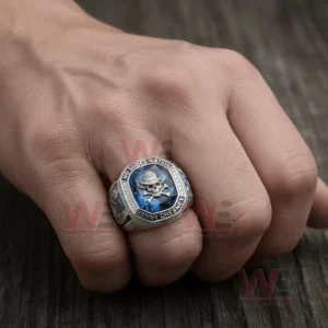 No Shoes Nation Kenny Chesney No Shoes Good Times Community Live in No Shoes Nation Ring 5 Hand wearing a silver ring with a blue gemstone face and skull emblem surrounded by diamond accents.