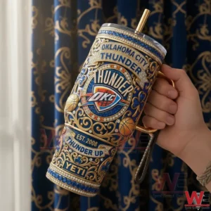 Oklahoma City Thunder 2008 Thunder Up Yeti 40oz Tumbler 3 A hand holds an Oklahoma City Thunder insulated tumbler decorated with ornate design elements team logo and historical details in front of a patterned curtain backdrop!