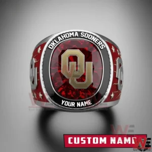 Front view Oklahoma Sooners ring with red gemstone top raised gold OU logo Oklahoma Sooners text custom name border star accents and bold red side panels!