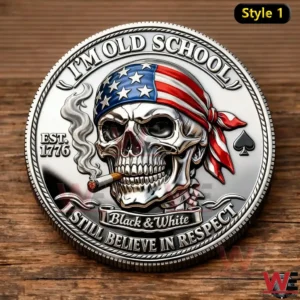 Close up of a silver coin showing a skull with an American flag bandana and cigar with Im Old School Est 1776 and I Still Believe In Respect text.