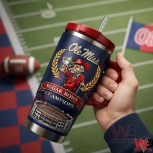 Hand holding a navy and red Ole Miss Sugar Bowl Champions tumbler with trophy mascot and stadium artwork on a football field background!