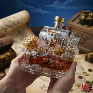 A clear ship shaped whiskey bottle inspired by the Thousand Sunny with golden details pirate emblem and amber liquid held in hands over a treasure themed background!