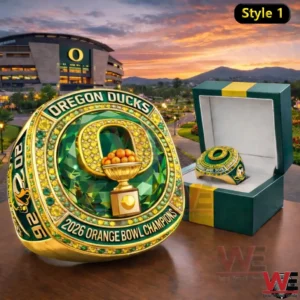 Oregon Ducks championship ring with green and gold detailing beside an open presentation box with a stadium and sunset background!