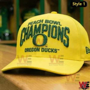 Yellow Oregon Ducks Peach Bowl Champions cap with green embroidered lettering and the O logo displayed on a wooden table in a locker room!