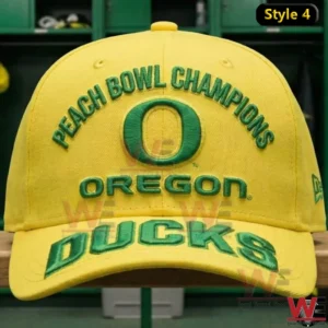 Front view of a yellow Oregon Ducks Peach Bowl Champions cap with arched text Oregon O logo and large Oregon Ducks lettering in a locker room!