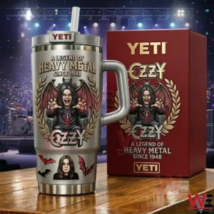 Silver metal music themed tumbler with dramatic artwork standing on a wooden surface next to a red box with a concert stage in the background!