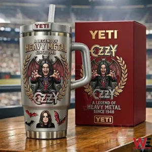 Metal rock themed tumbler with bold illustration shown next to a red box on a table with a stadium crowd blurred behind!