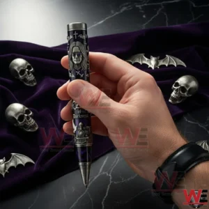 Hand holding a gothic style collector pen with Prince of Darkness design featuring skull and bat elements on a dark velvet background!