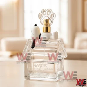 A Snoopy inspired anniversary perfume bottle shaped like a house roof with a paw cap displayed on a bright indoor surface!