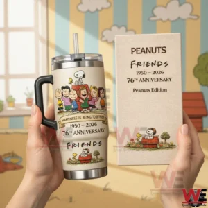 Peanuts Friends 1950-2026 76th Anniversary Tumbler Cup 3 Hands holding a cream Peanuts Friends anniversary tumbler with handle and straw beside a matching edition box with a cheerful cartoon style background! ``