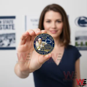 Person holding Penn State White Out commemorative coin!